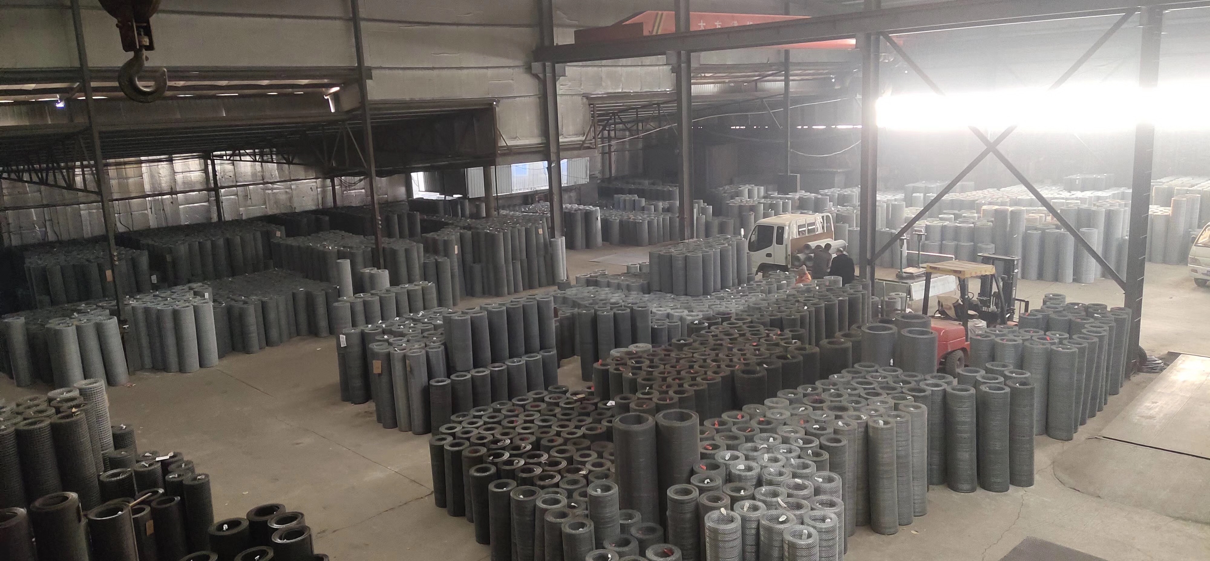 Woven wire screen rolls stored in the factory